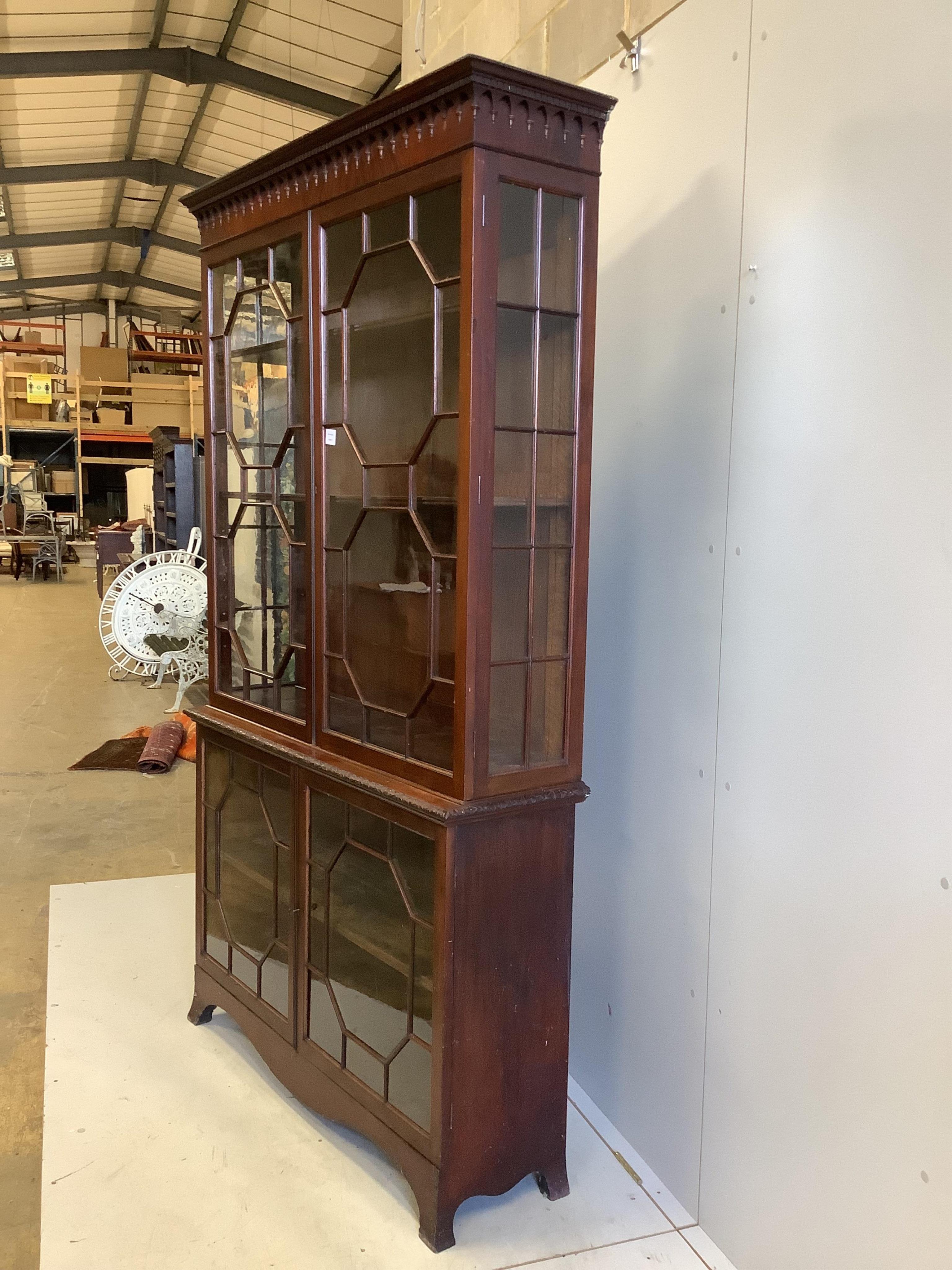 A George III style mahogany bookcase, enclosed by two pairs of astragal glazed doors, width 122cm, depth 35cm, height 214cm. Condition - fair to good